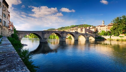 Obraz premium old stone bridge over a large river in european city