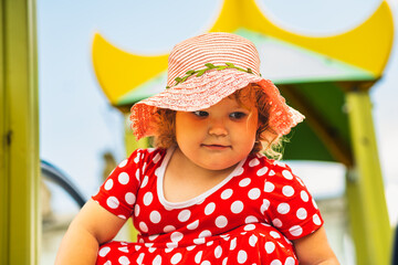 Child Playing on Colorful Playground Equipment During a Sunny Day in the Park