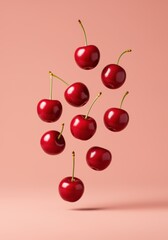 Floating ripe cherries on pink background.