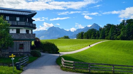 Scenic view of a traditional house and lush green fields