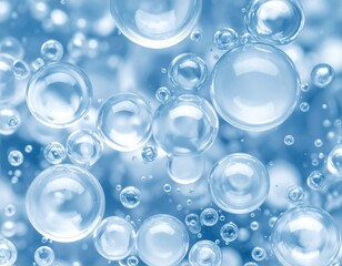 A close-up view of numerous translucent, light-blue bubbles.  They vary in size and are gently dispersed throughout a blurred, soft-focus background of the same color. 