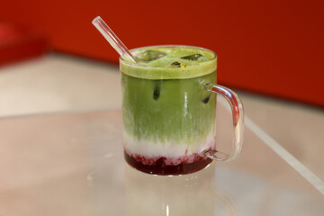 Iced matcha drink on a neutral background soft shadows summer drinks.