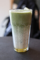 Iced matcha drink on a neutral background soft shadows summer drinks.