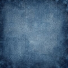 Faded blue denim fabric background with rugged canvas effect. Worn indigo dye creates vintage texture with subtle rough details on cotton material. Versatile backdrop offers classic, textured base