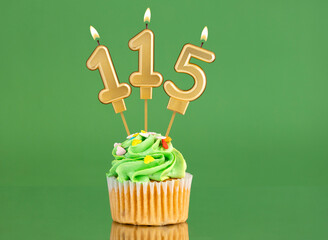 Birthday card with candle and cupcake - Number 115 on a green background
