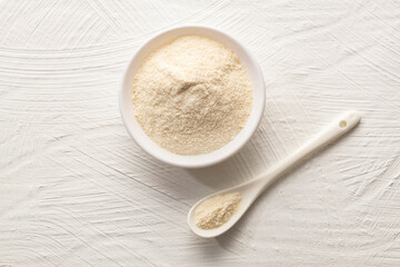 Organic gelatin powder also called hydrolyzed collagen - White powder in the bowl and spoon