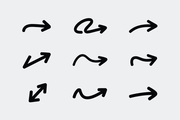 Collection of nine hand drawn black arrows on a light gray background