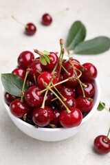 Wet ripe cherries on light table, closeup
