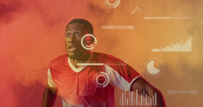 Sprinting male athlete wearing red sports jersey in smoke-filled studio, with digital HUD elements