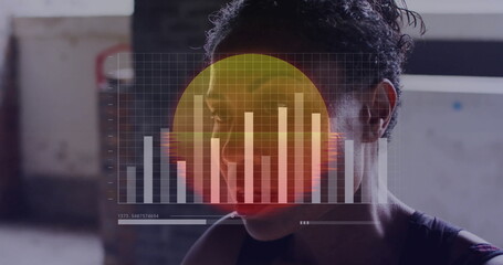 Shadow boxing female athlete throwing punches inside warehouse gym, with digital overlay chart