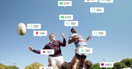 Lifting two striped jersey players reaching for rugby ball on grassy field, with social media icons