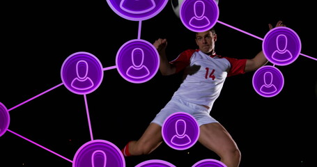 Jumping soccer player wearing white-red jersey 14 on field at night, with purple network icons