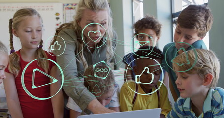 Pointing teacher guiding students around laptop in classroom, with social media icons