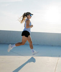 Running freely on a sunny rooftop during an early morning workout