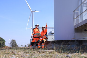 Engineer team man and woman working together survey plan construction wind turbine sustainable...