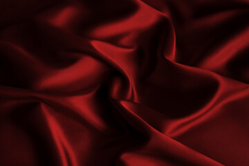 Lustrous crimson burgundy deep red satin drapes in fluid waves and gentle shadows, radiating...
