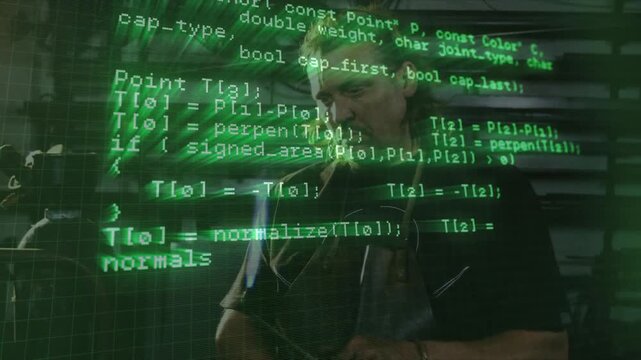 Green code overlay appearing on man standing in workshop while software algorithms scrolling