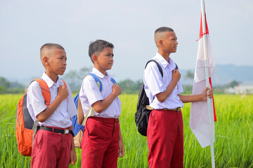 Indonesian Students In Uniform With Flag Showing Respect And National Pride