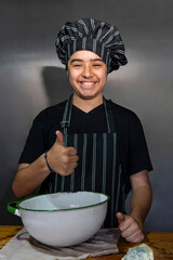 Young chef in training showing a thumbs up gesture