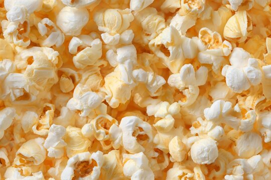 Delicious natural popcorn, full frame view from top. Food snack seamless pattern. Appetizing light background for movie party.