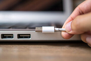 close up of a hand holding a usb cable