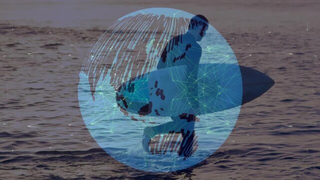 Male surfer with surfboard entering knee-deep water for surfing, showing tech with rotating globe