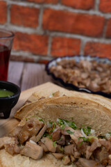 Close-up of carnitas taco on a wooden table with a blurred background, Mexican food