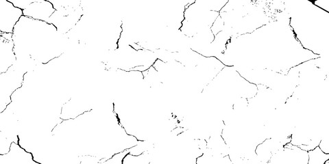 white surface with a network of black cracks across the surface area.