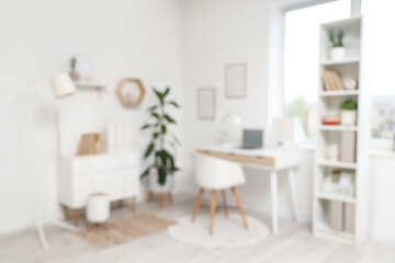 Comfortable workplace with laptop in modern office. Blurred view