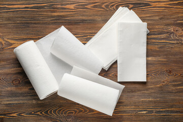 Rolls of paper towels on wooden background