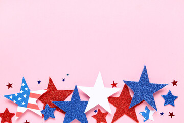Paper stars in colors of USA flag for Independence Day on pink background