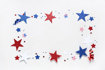Frame made of paper stars with confetti in colors of USA flag for Independence Day on white grunge...