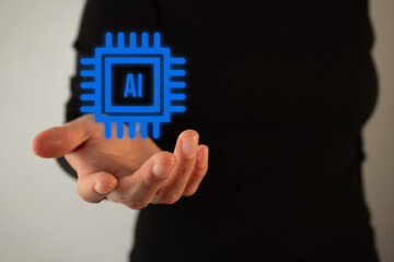 person's hand holding an icon of an artificial intelligence chip