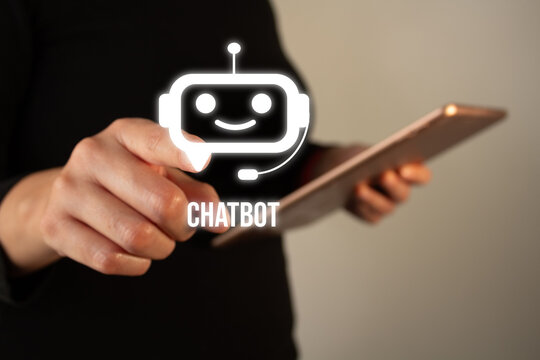 Businesswoman holding a tablet while pointing at a chatbot icon
