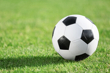 Soccer ball on green grass, closeup