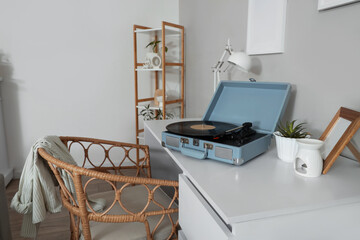 Record player and plant on desk in living room