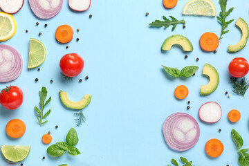 Different fresh vegetables with basil leaves, arugula and citrus fruits on blue background