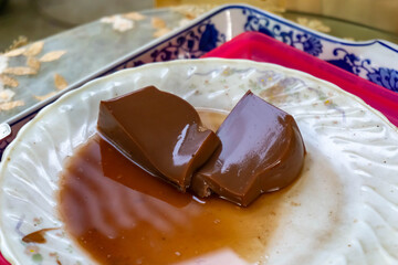 Two slice of smooth, glossy chocolate pudding