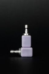 Close-up of two CAD/CAM dental ceramic blocks used for crown or veneer milling. Dental technology and prosthetics materials on black background.