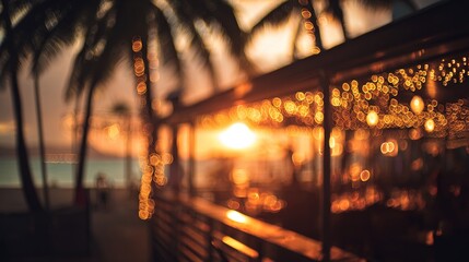 Golden sunset glow illuminating a beach restaurant with soft reflections of string lights.