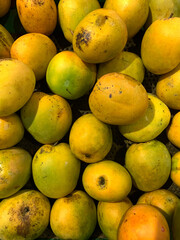 Stack of tropical yellow ripe mangoes displayed in the market