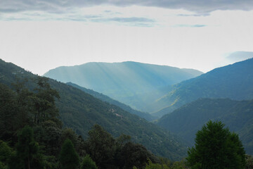 Sun rays falling on Himalayan mountain range, scenic beauty of layers of mountains, Okhrey, sikkim, India. Okhrey village a remote place in Sikkim where mountain range view is enjoyed by tourists.