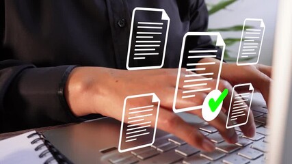 Close-up of a businessman's hands working on a laptop with several document icons floating around - Powered by Adobe