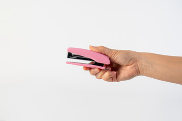 Pink stapler in hand on white background