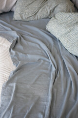 closeup of messy bed at early morning 