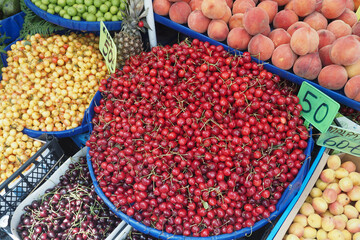 Colorful fruit display at local market in summer season