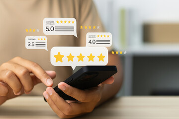 Customer hand using smartphone with floating star rating reviews for service feedback and user...