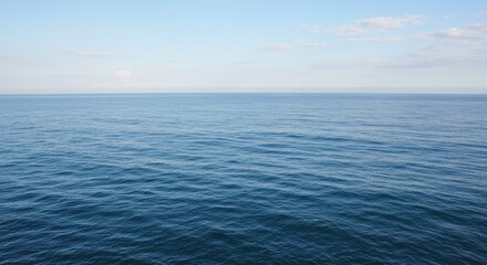 Obraz premium Minimalist Open Water Surface with Deep Blue Ocean and Pale Blue Sky Horizon