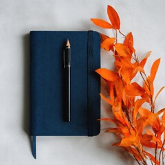 Blue Book with Pen and Orange Flowers Still Life