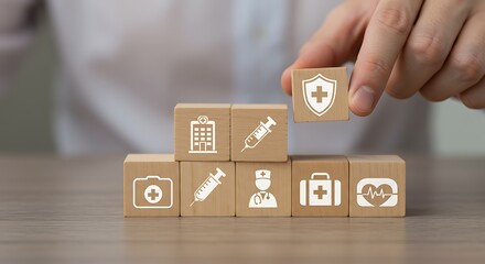 A hand places a wooden block with a health shield icon, representing healthcare insurance and medical protection